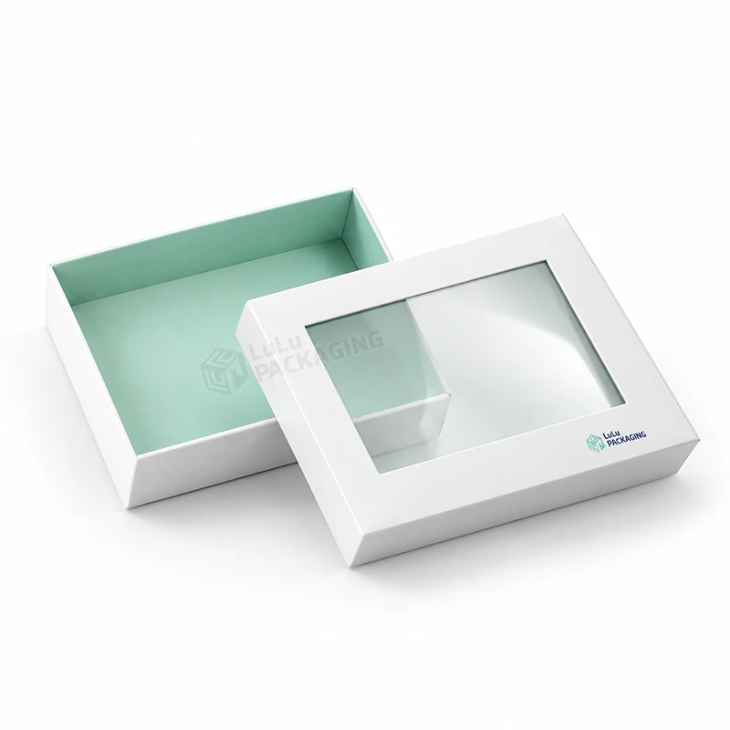 White partial cover rigid box with a clear window lid set beside a mint green base, with the LuLu Packaging logo