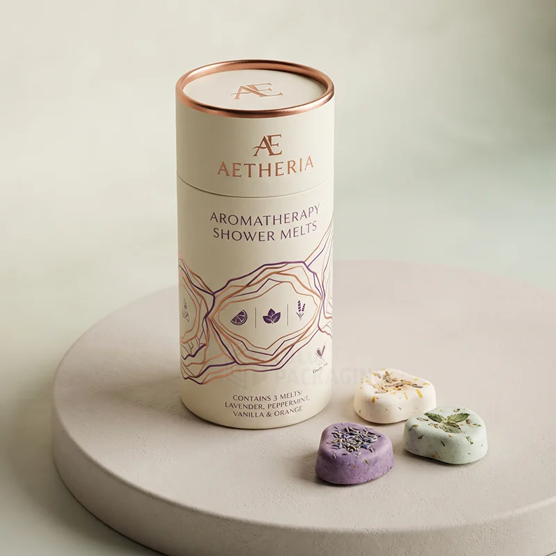 Cream paper tube with copper rim for aromatherapy shower melts, three melts in front
