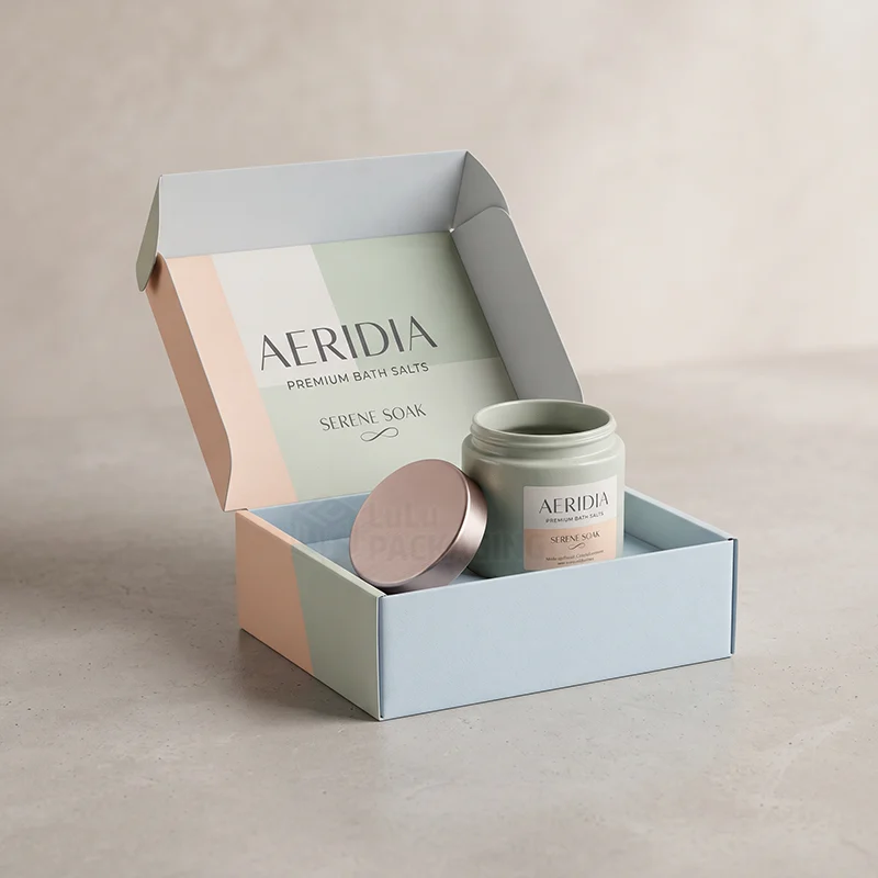 Pastel bath salt mailer box open to show a jar of bath salts with its lid