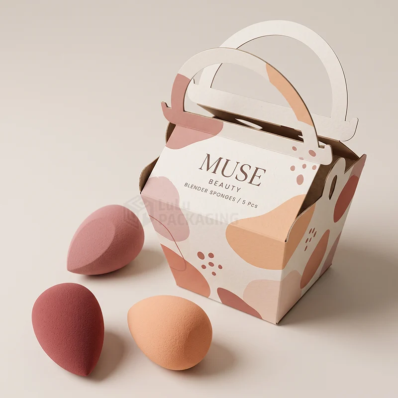 Printed carry box with arched handle beside three makeup sponges in different colours