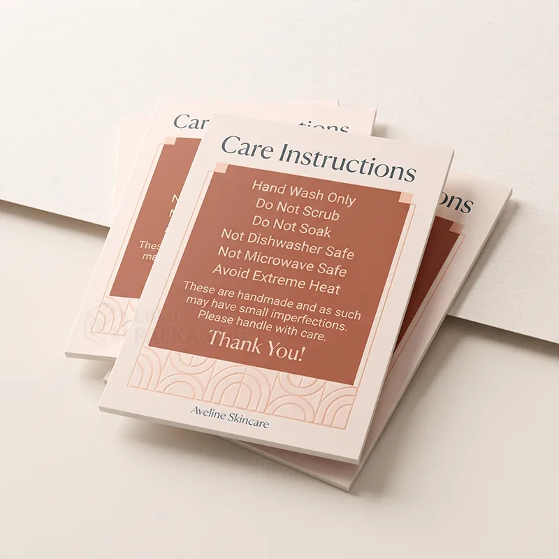 Stack of blush and terracotta care instruction cards for handmade items with an arched line pattern