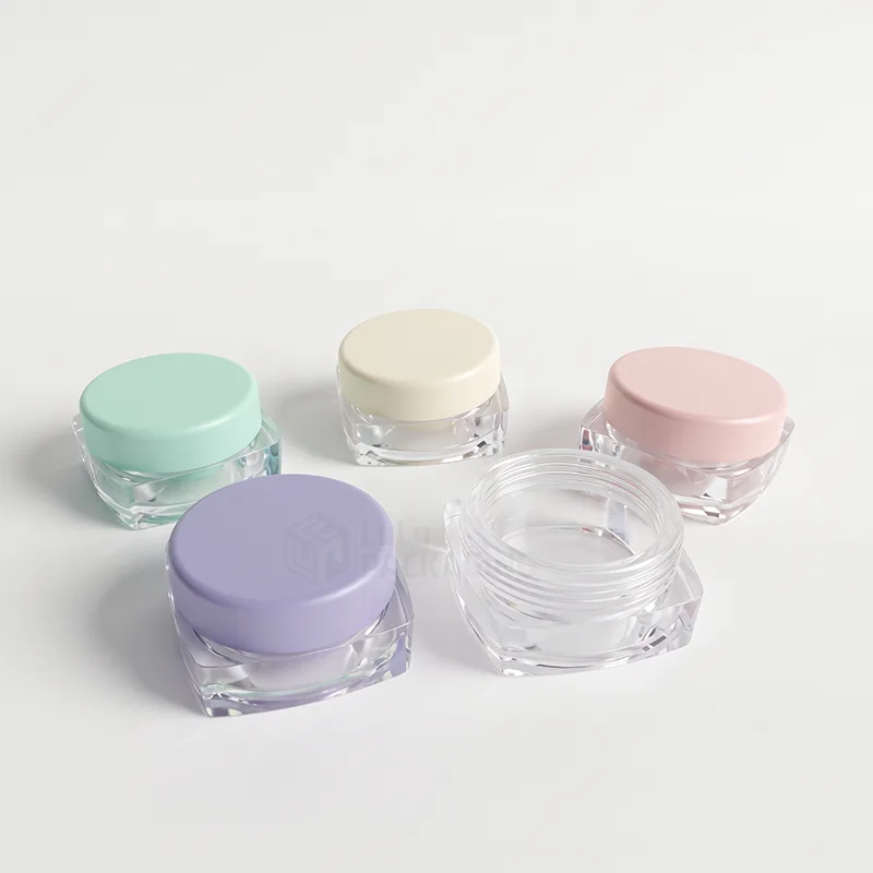 Five clear square-base lip balm pots with mint, cream, pink and lilac lids, one open and empty