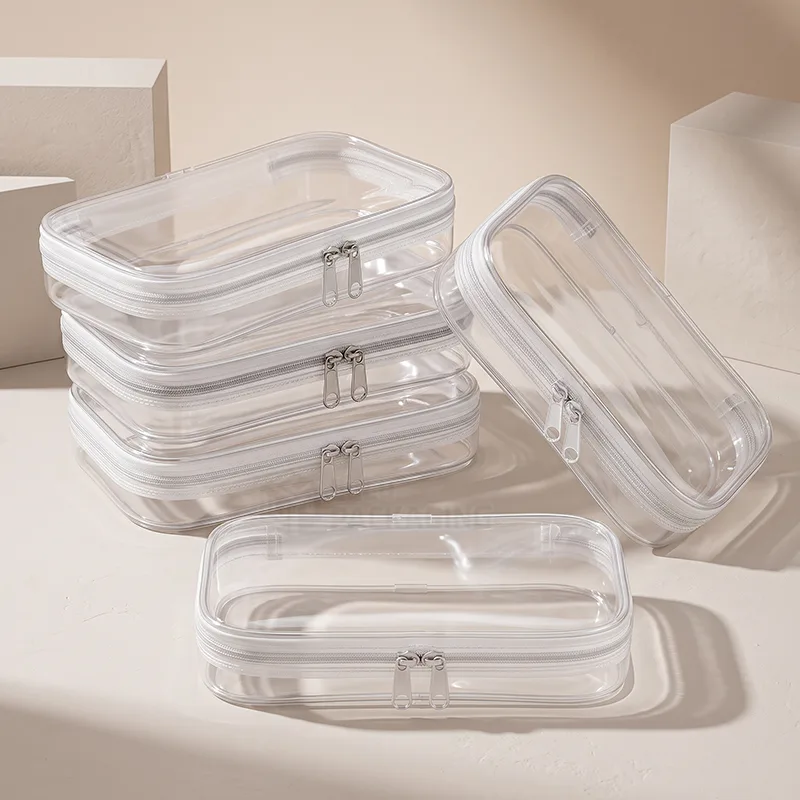 Stacked clear zipper pouches with white trim and double zipper pulls