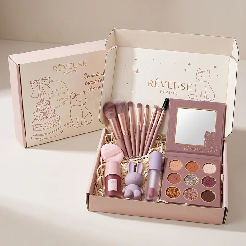 Sage mailer box with foil logo holding a palette, serum, lash and skincare tools