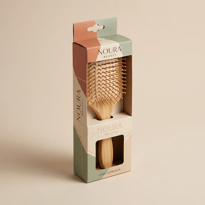 Tall printed comb box with hang tab and windows showing a bamboo paddle brush