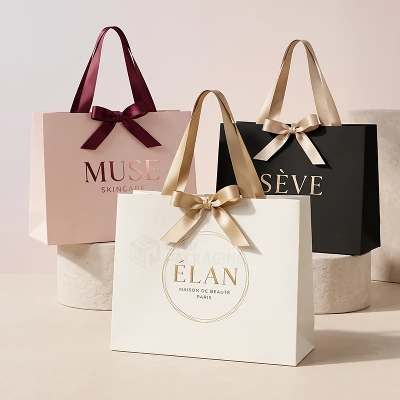 Pink, white and black boutique bags with satin ribbon bow handles and foil printed logos