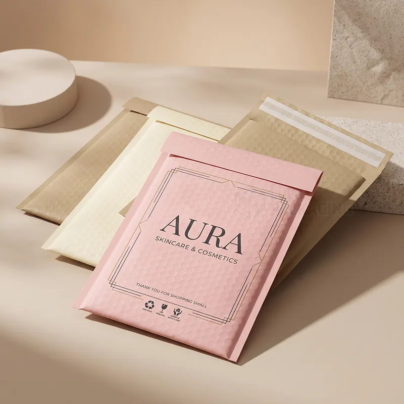 Pink, cream and kraft bubble mailers with a printed logo and peel and seal strip