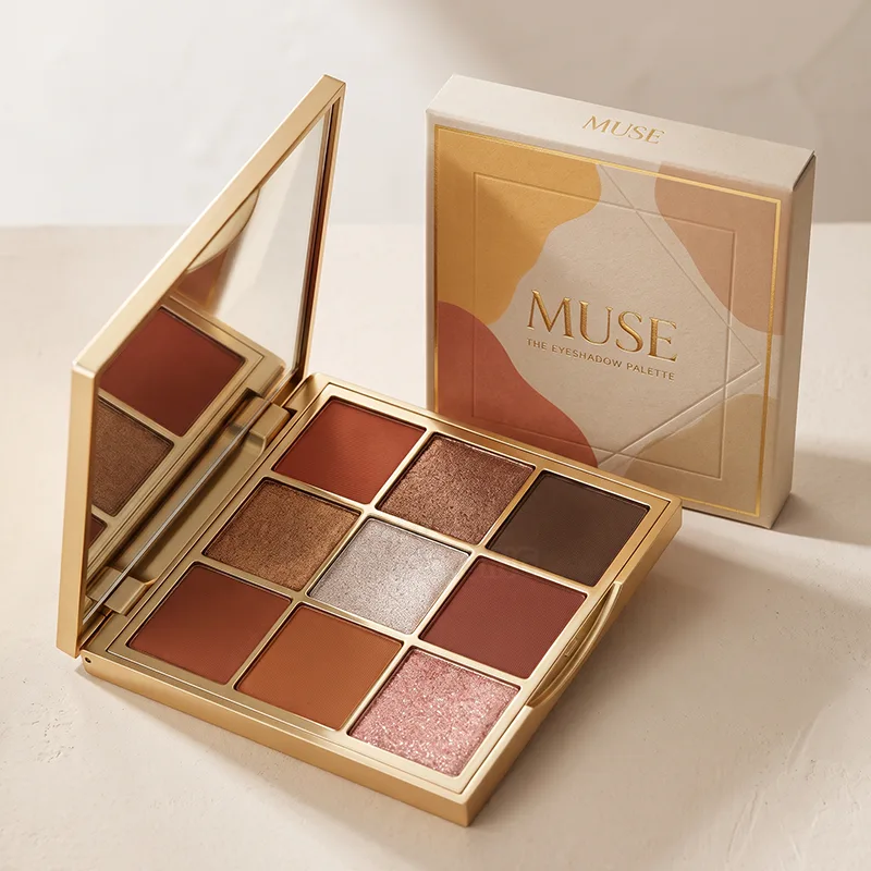 Gold nine pan eyeshadow palette with a mirror, open beside its printed box