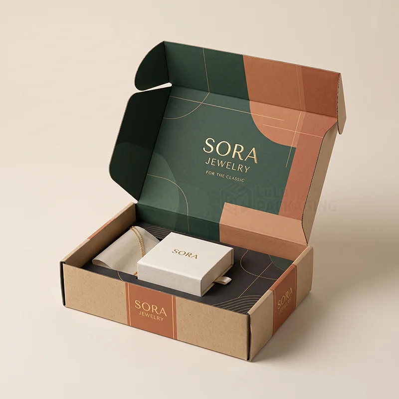 Kraft jewellery mailer box with a printed green interior holding a jewellery box and pouch