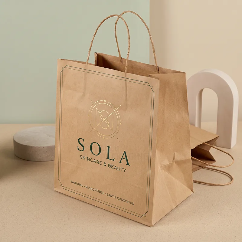 Printed kraft paper bag with twisted handles and a gold foil logo