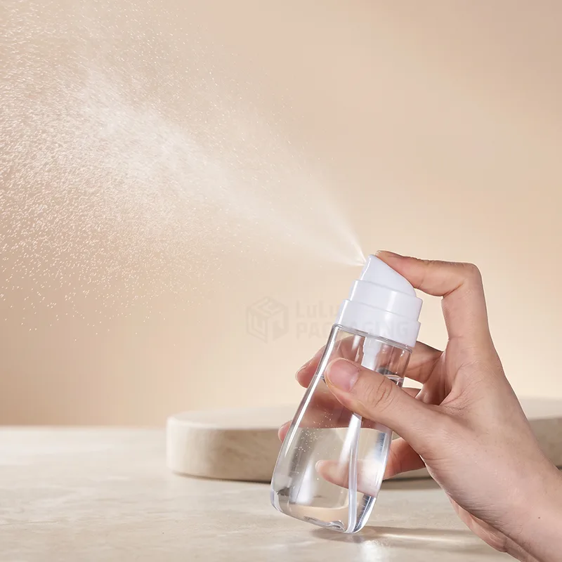Hand pressing a clear fine mist spray bottle that releases a soft cloud of mist