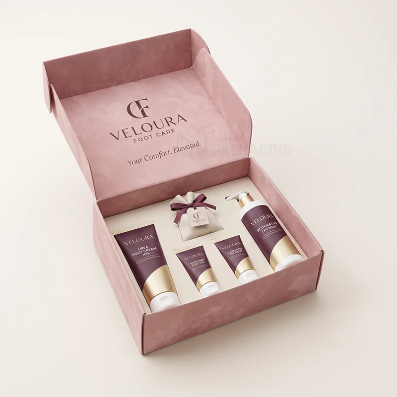 Pink foot care mailer box open to show tubes, a pump bottle and a pouch in an insert