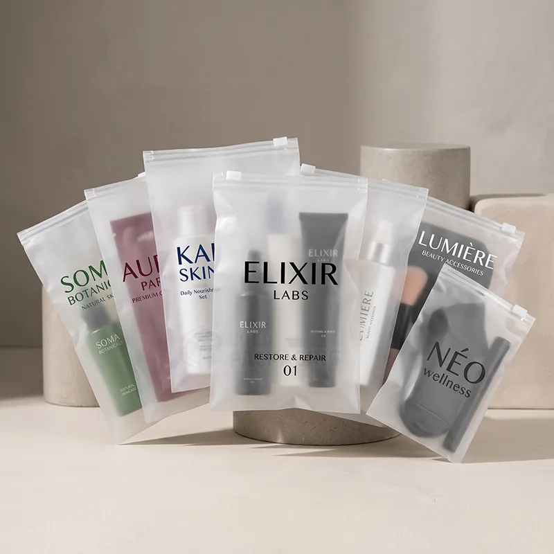 Row of frosted ziplock bags holding skincare and makeup sets with printed logos