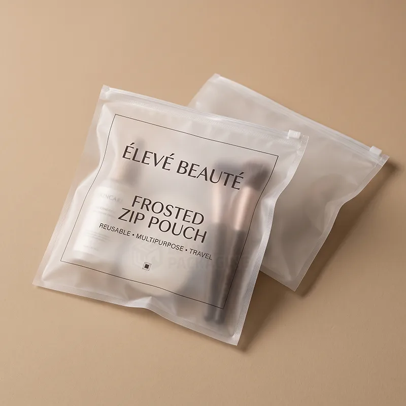 Frosted zip pouch holding makeup brushes and skincare with a printed logo