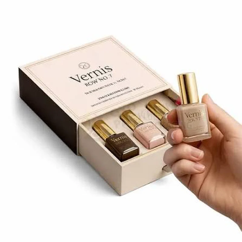 Pale pink drawer box with three gel polish bottles while a hand holds one up