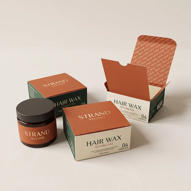Hair wax and styling gel boxes, one open to show a printed interior, with an amber jar