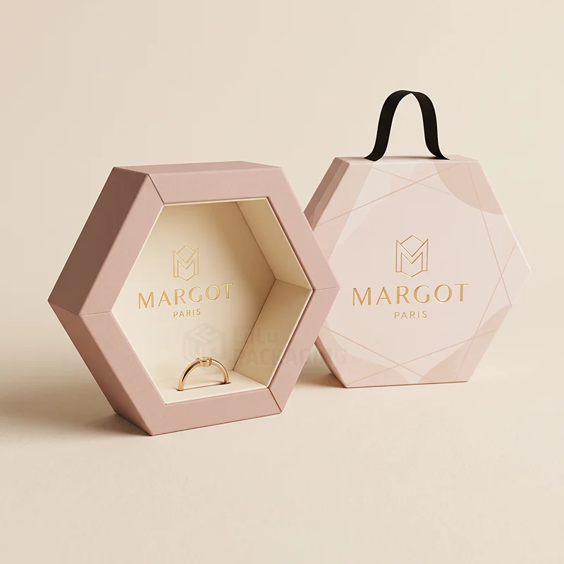 Pink hexagon luxury jewellery box with a ribbon handle, one open showing a gold ring