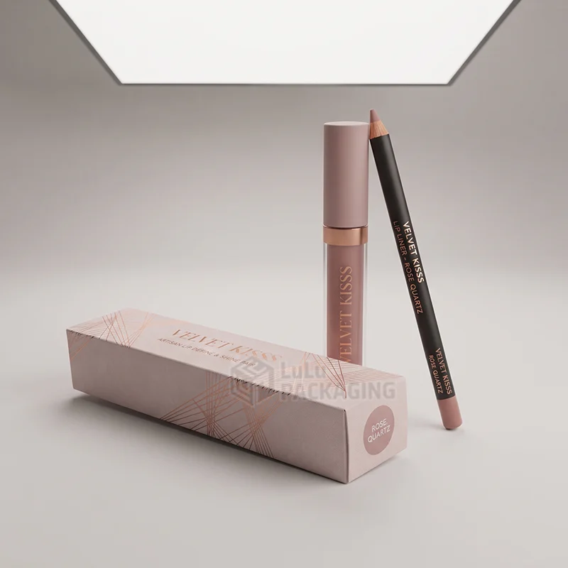 Blush pink rectangular lip liner box with rose gold foil line pattern beside a matching liquid lipstick and lip liner pencil.