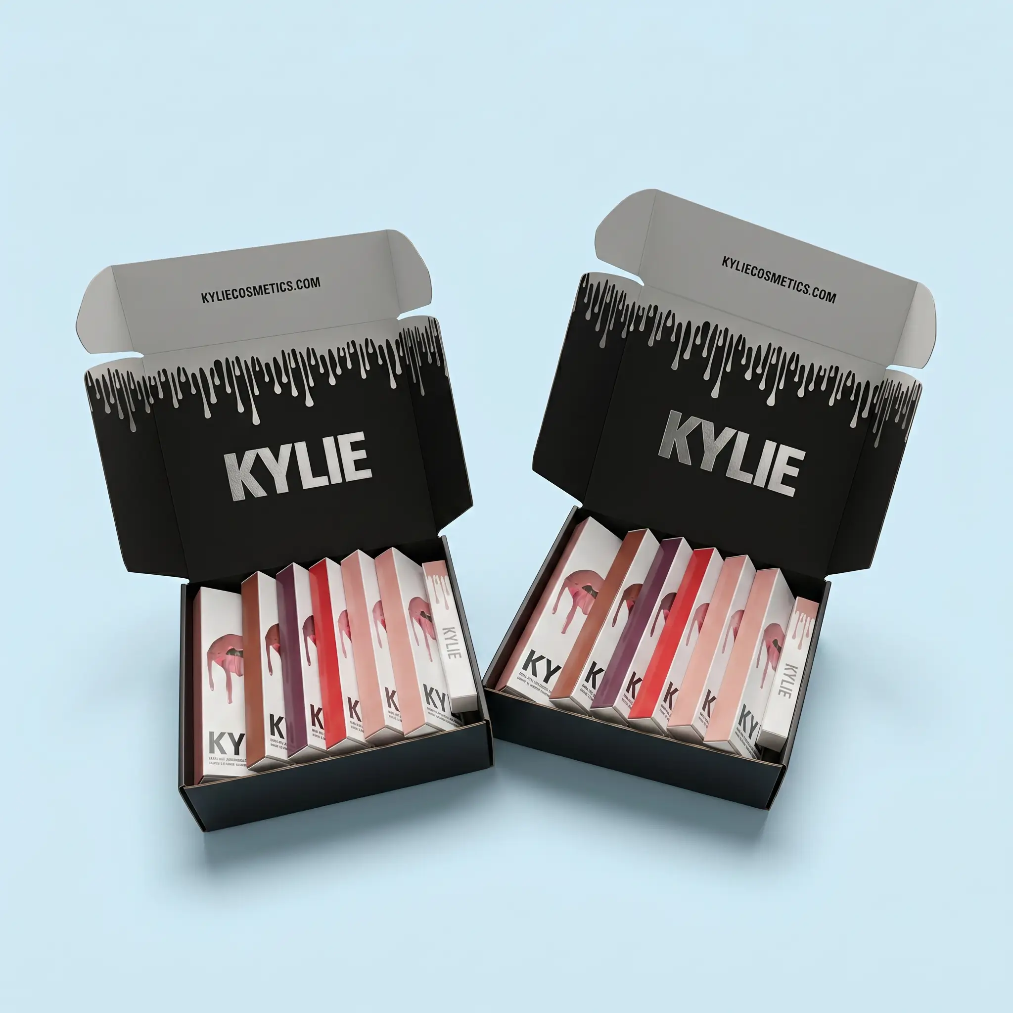 Two open Kylie Cosmetics lipstick boxes showing multiple lipsticks inside, with black and white drip design on a light blue background.