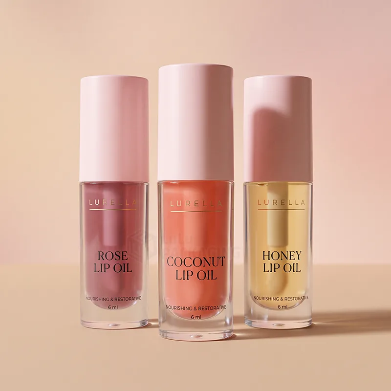 Three clear lip oil tubes in rose, coconut and honey shades with pink caps