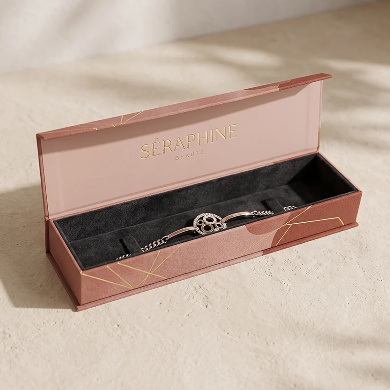 Long rose magnetic bracelet box with a black velvet insert and a silver chain bracelet