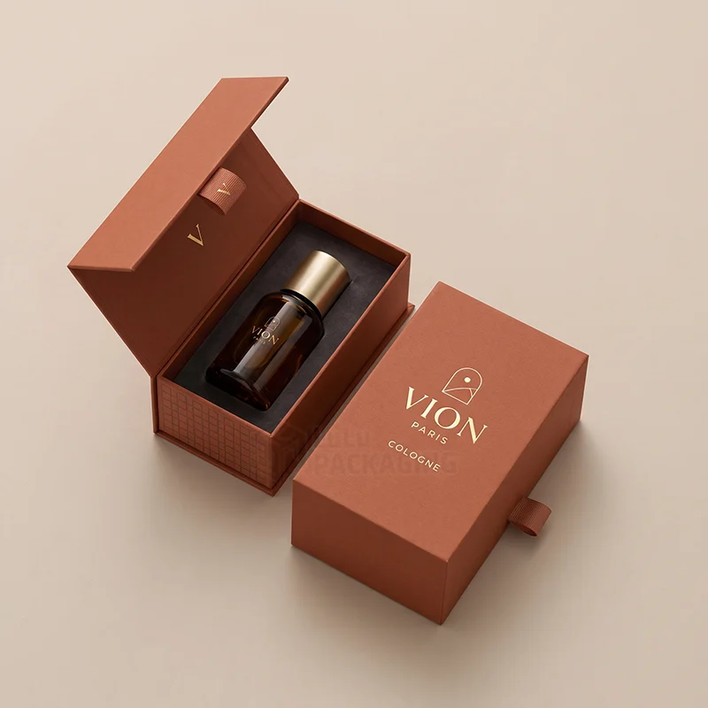 Terracotta magnetic cologne box open with an amber bottle in a foam insert beside a matching drawer box