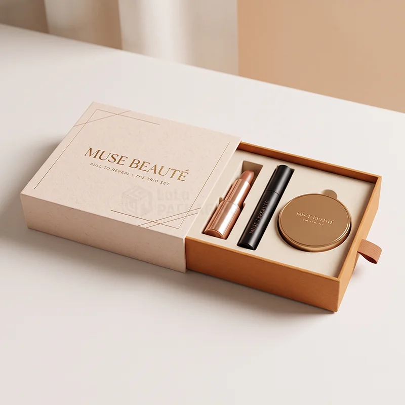 Cream drawer box slid open to show a lipstick, mascara and compact in an insert
