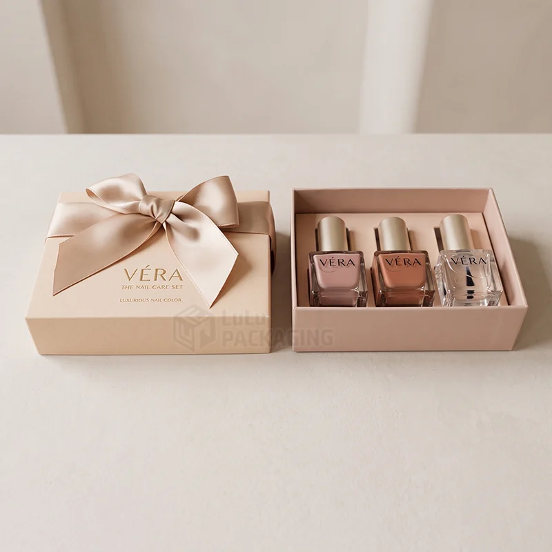Peach nail care set lid with satin bow beside the base holding three polish bottles