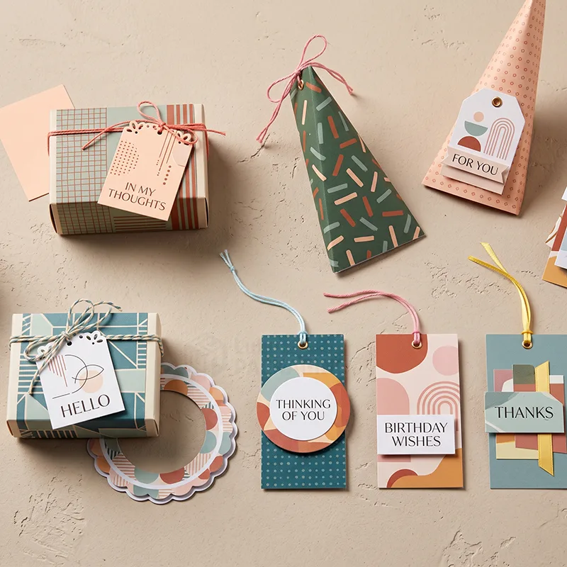 Patterned gift tags reading Hello, Thanks, Birthday Wishes and Thinking of You beside small wrapped gift boxes