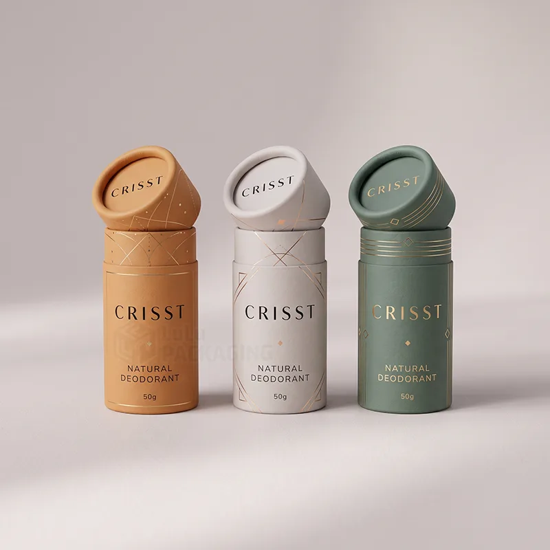 Three paper deodorant tubes in orange, grey and green with gold foil patterns and lids