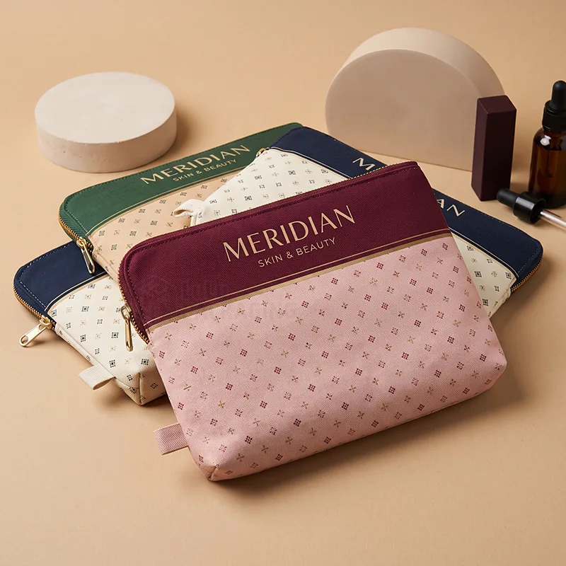 Patterned canvas zipper pouches with contrast top panels and gold printed logos