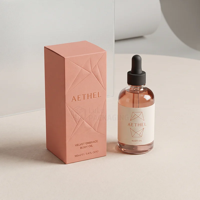 Coral body oil box with embossed geometric lines next to a glass dropper bottle