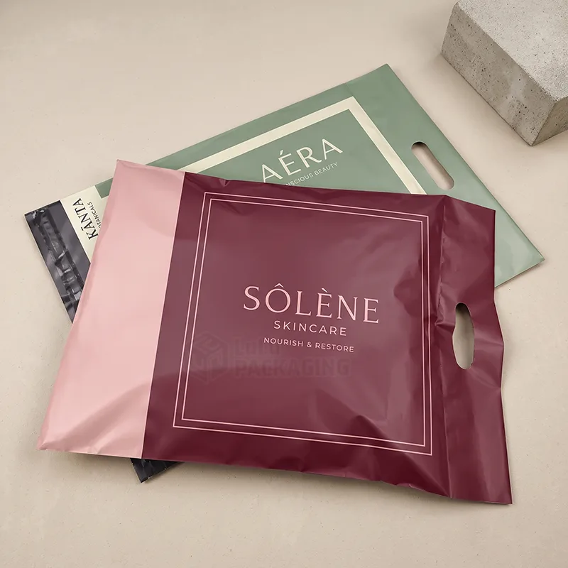 Burgundy and sage poly mailers with die cut handles and printed logos