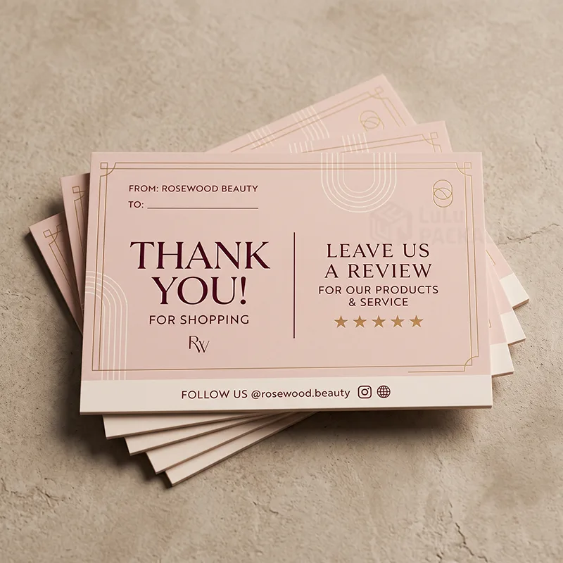 Fanned stack of blush leave us a review cards with thank you message, gold stars and follow us line