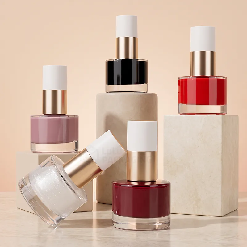 Round glass nail polish bottles in red, black, pink and glitter with white and gold caps