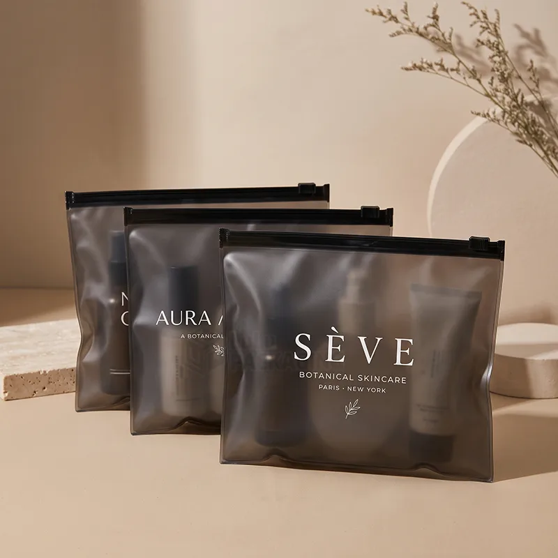 Smoky black frosted ziplock bags holding skincare bottles with a white printed logo