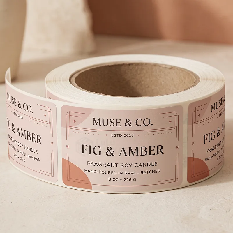 Roll of pale pink fragrant soy candle labels with fine line frames and terracotta shapes