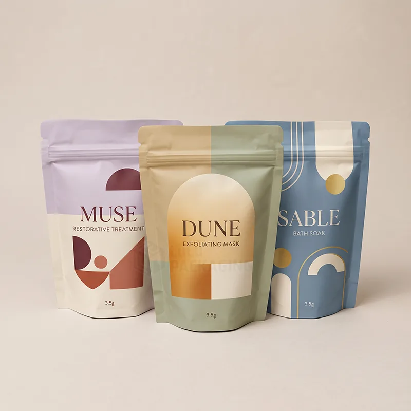 Three stand up mylar bags with zippers and bold printed designs for bath soak and masks