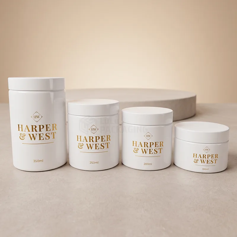 Four white cream jars from 100 ml to 350 ml with white lids and gold foil logos