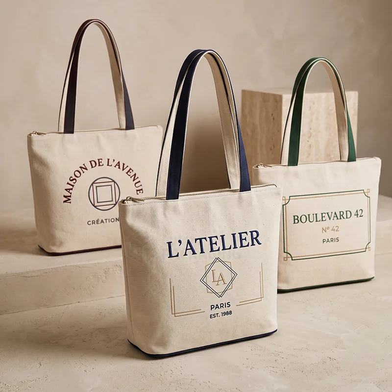Three natural canvas tote bags with zip tops, contrast colored handles and printed logos